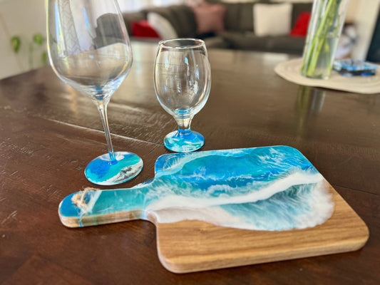 OceanWave cutting board with matching glasses for a couple. One wine and one beer glass. The food safe resin waves are on the base of the glasses only.