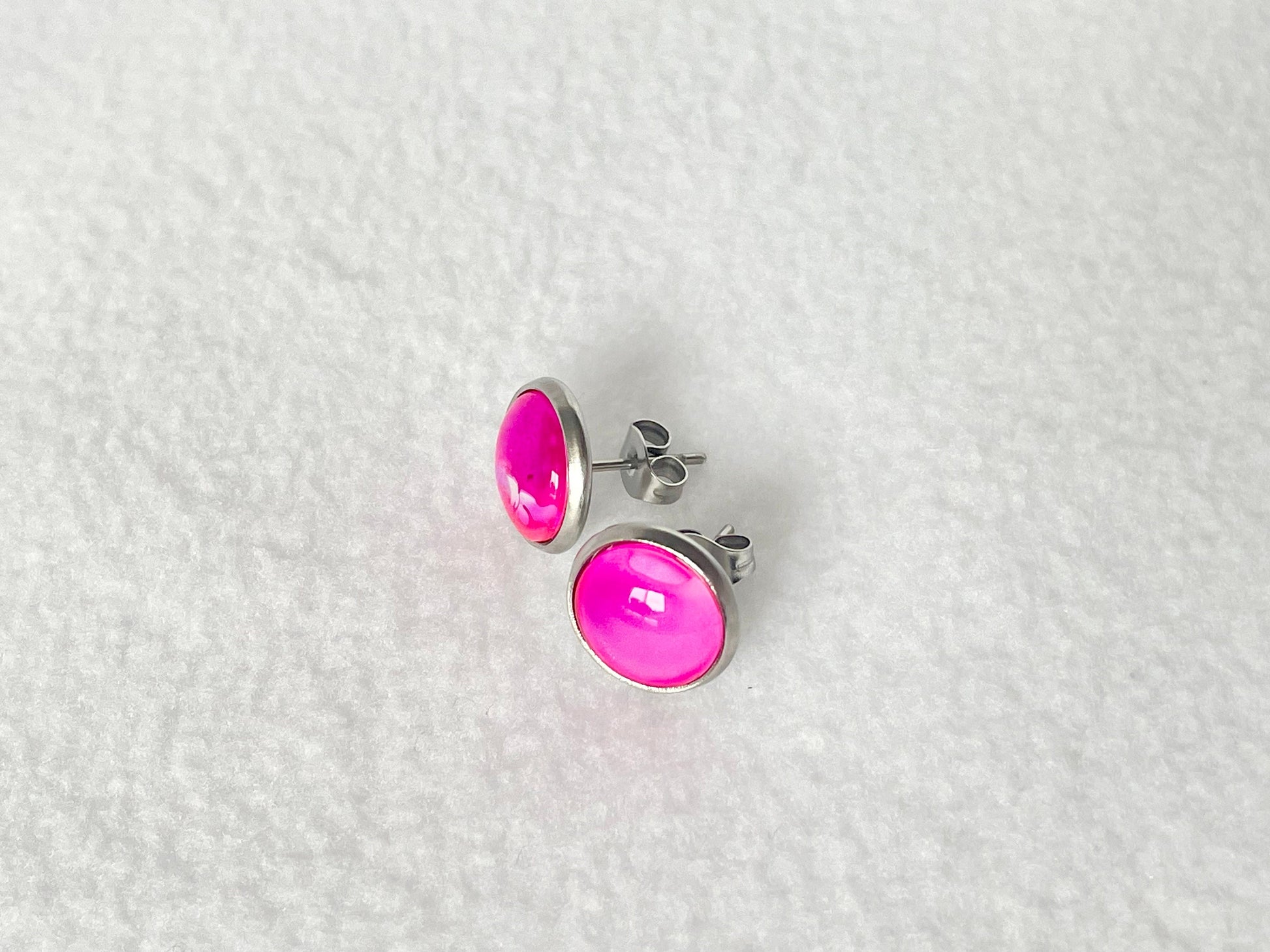 Bright pink stud earrings in stainless steal setting, hypoallergenic and lightweight.