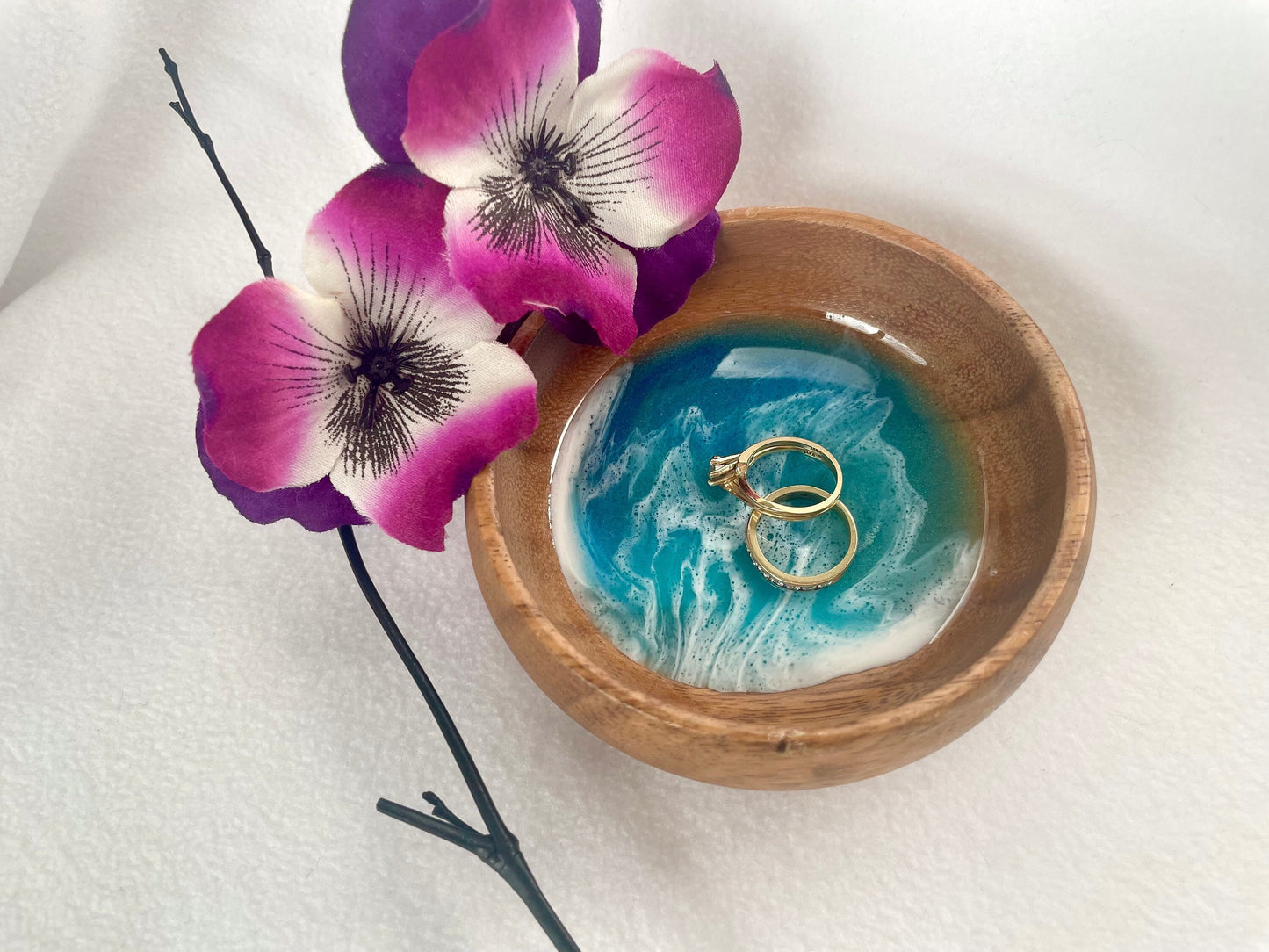 Round wood ring dish with blue and turquoise resin ocean waves with bright white foam.