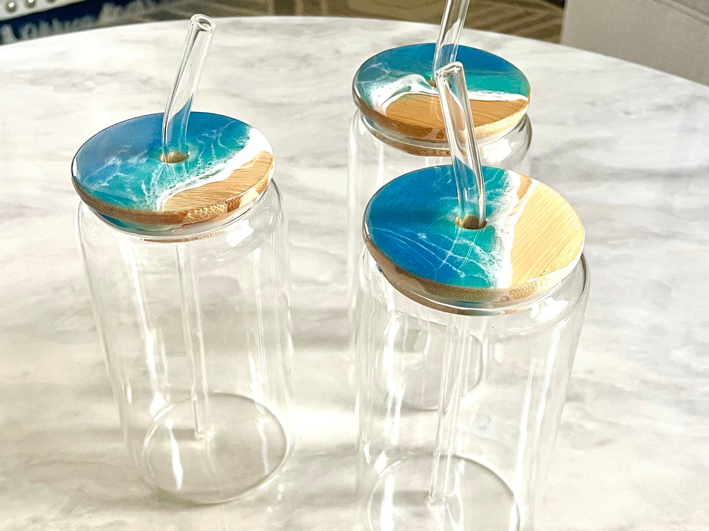 Resin Ocean Wave Drinking Glass with Bamboo Lid and Glass Straw for The Ocean Lover who wants that Coastal Vibe in home decor or bar ware.