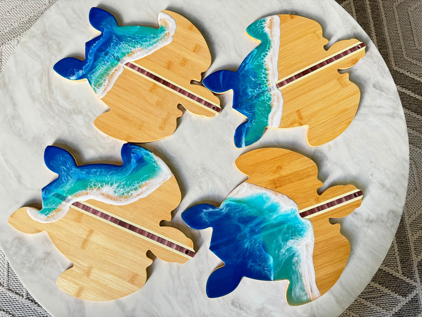 Turtle shaped cutting boards with resin ocean waves in bright blue and turquoise with white foam.