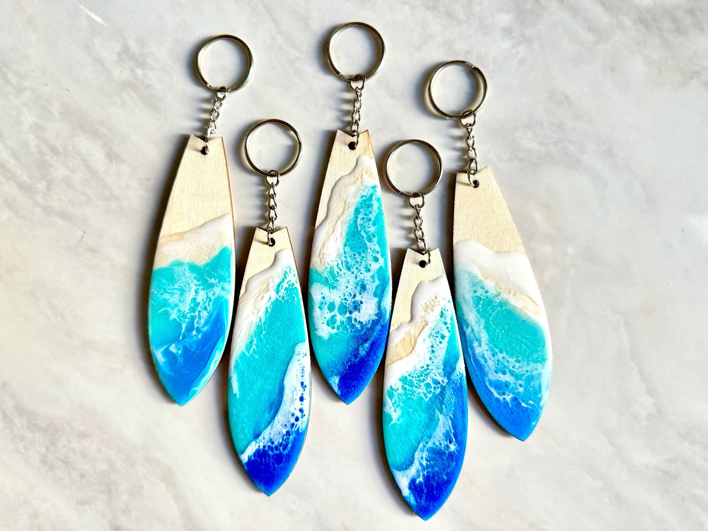 Surfboard Keychain, wood surfboard with resin ocean wave on both sides, with silver keychain.