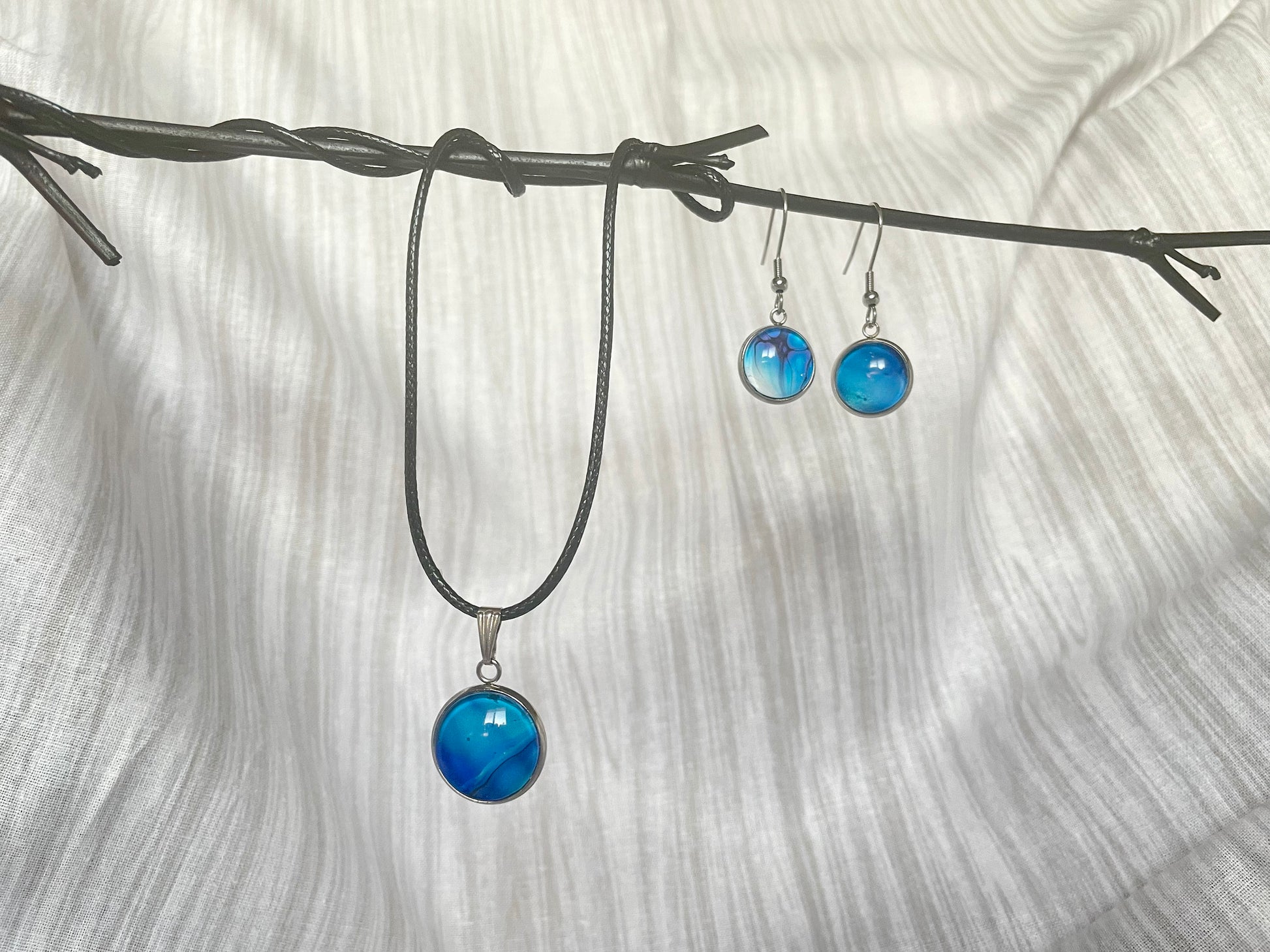 Pendant necklace and dangle earrings handmade jewelry set in multi-colored acrylic art pour in beautiful blues